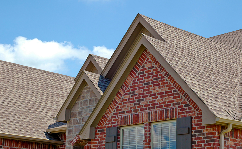 Side view of brick home with new roof.