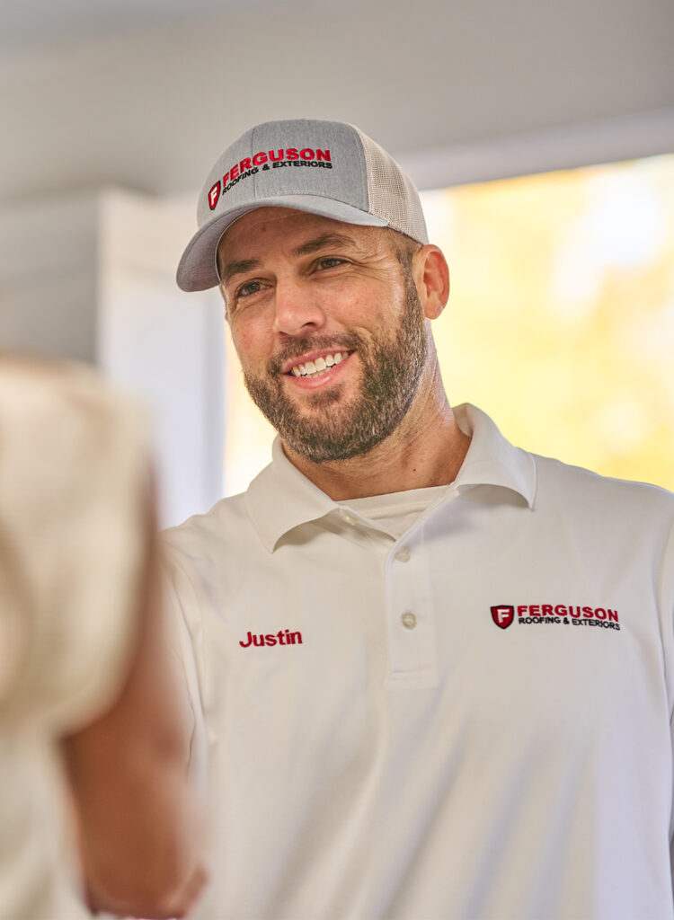 Close up of roofer shaking customer's hand.