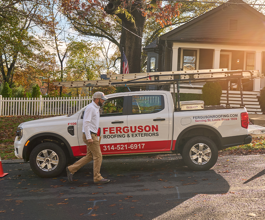 Ferguson roofer walking by his Ferguson truck.