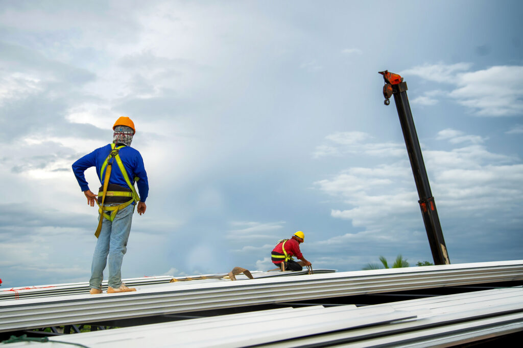 Roofers on top of commercial building.
