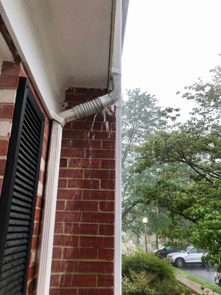 Rain overflowing gutters and downspout.