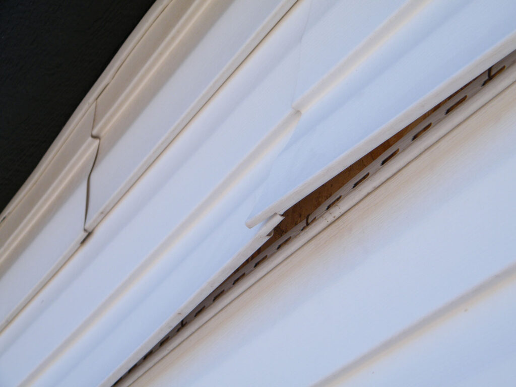 Close up of residential siding damage.