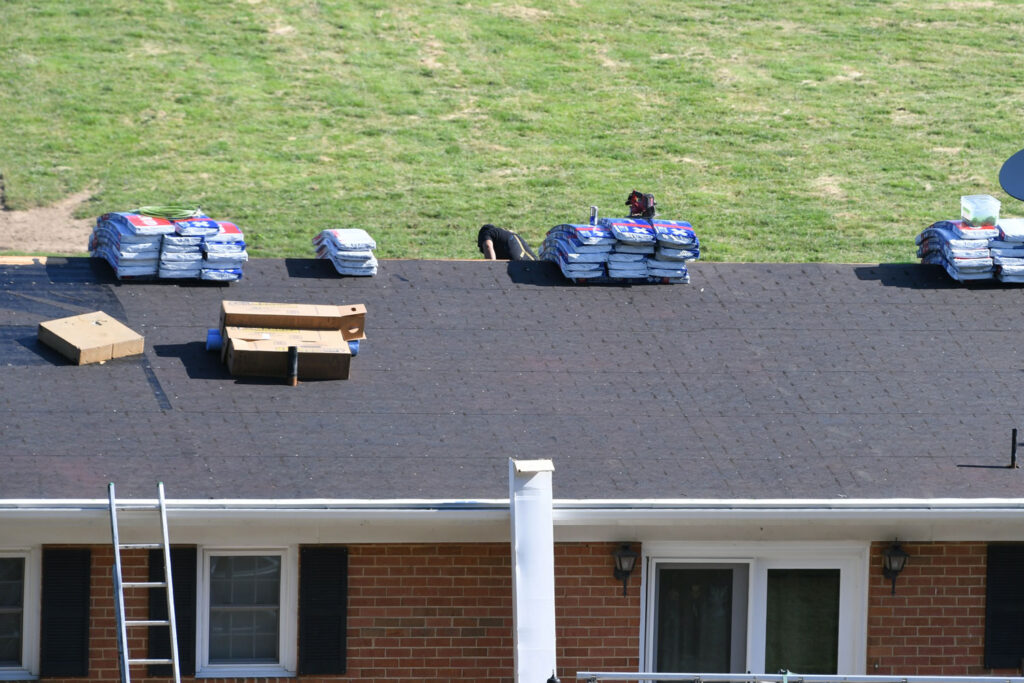 Roofers repairing a residential roof.