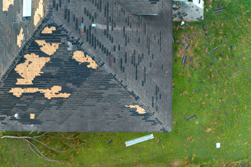 Bird's eye view of a damaged roof in need of repair.